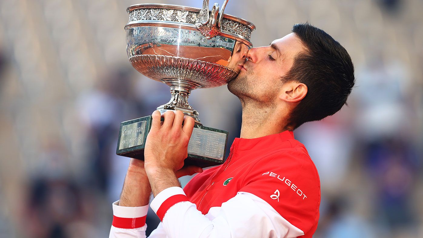 Novak Djokovic of Serbia celebrates as he kisses the trophy after winning his Men&#x27;s Singles Final match against Stefanos Tsitsipas of Greece during Day Fifteen of the 2021 French Open at Roland Garros on June 13, 2021 in Paris, France