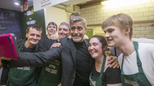 Clooney with the staff at Social Bite, a cafe which hires homeless workers.  (Getty)