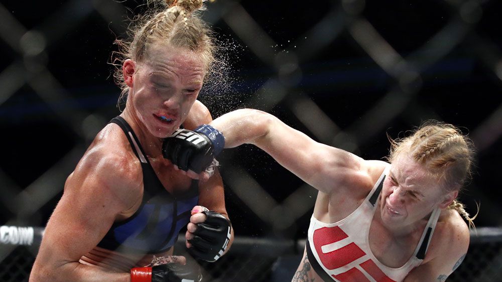 Valentina Shevchenko lands a big right on Holly Holm's chin (AAP)