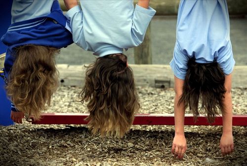 Children at a Melbourne primary school hang from the monkey bars