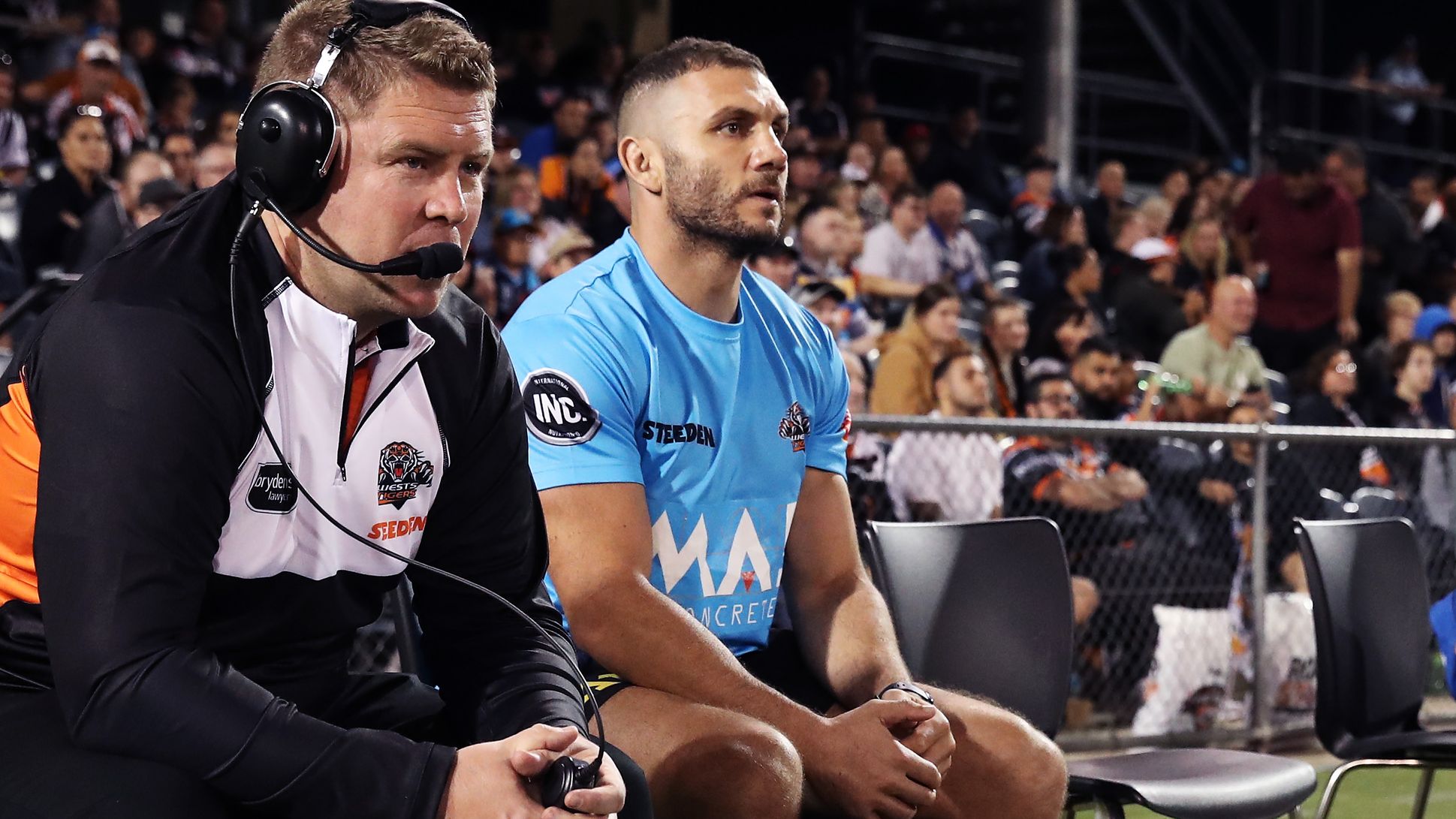 Robbie Farah and other Tigers support staff watch from the bench.