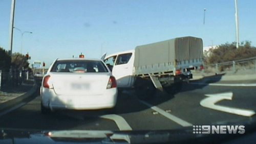 Police boxed in the car as it stopped at lights on the Row Highway. (9NEWS)