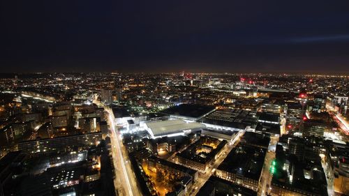 The massive dig site can be seen lit up at night.