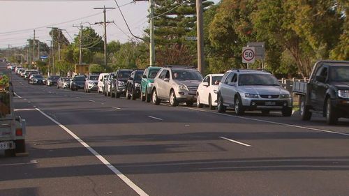 Cars wait in line for the testing clinic in Parkdale, Melbourne.