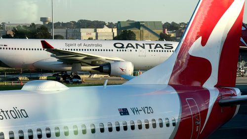 Qantas aircrafts are seen on the tarmac at Sydney Airport