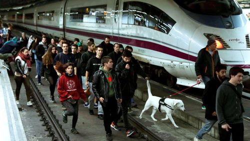 Demonstrators, most of them students, block the tracks at Sants train station during a protest against the imprisonment of pro-independence leaders and to demand their freedom, in Barcelona. (AAP)