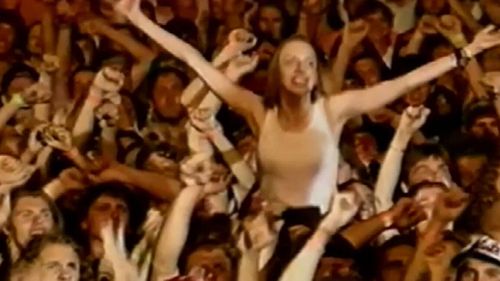 A Guns N' Roses fan crowd surfs at the band's notorious 1993 concert.