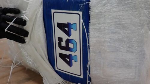 A closeup of a package containing cocaine in Sydney. It has a numbered label reading '464' on it.
