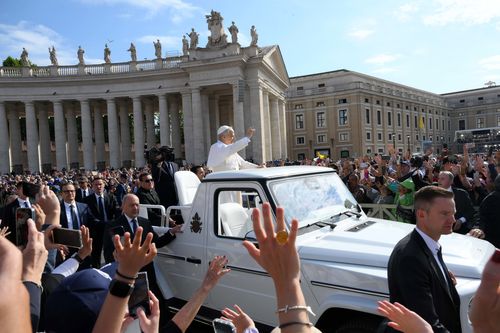 Pope Leo XIV waves as he arrives ahead of the Inauguration Mass.