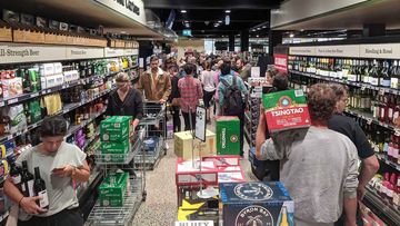 Checkout queues snake down the aisles at a Dan Murphy&#x27;s in Brunswick late last month.