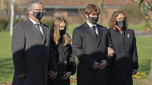 The family of Captain Tom Moore, from left, son-in-law Colin Ingram, granddaughter Georgia, grandson Benjie and daughter Hannah Ingram-Moore arrive for his funeral, at Bedford Crematorium, in Bedford, England, Saturday, Feb. 27, 2021.