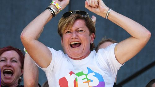 Christine Forster, the sister of former Prime Minister Tony Abbott, celebrates after watching the same sex marriage vote result announcement in Sydney.