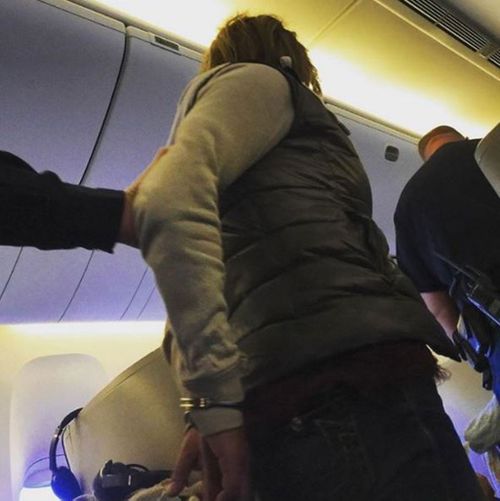 A woman is restrained on a British Airways flight. (Instagram @themanship)