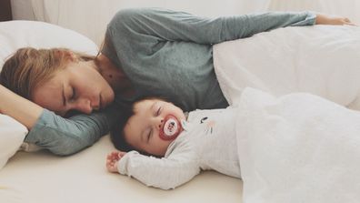 Baby sleeping with mother