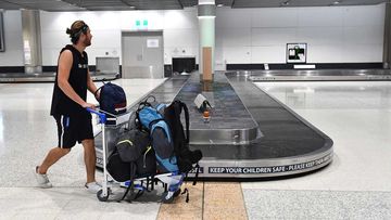 A man walks past an empty baggage carousel at Brisbane Airport.