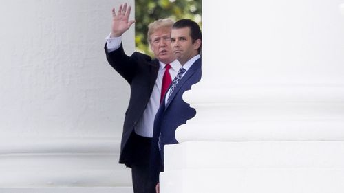 US President Donald J. Trump (L) waves beside Donald Trump Jr. (R) from the North Portico before departing the White House in Washington, DC, USA, 05 July 2018. 