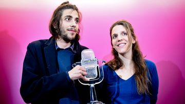 Winner of 2017 Eurovision contest Salvador Sobral accompanied by his sister Luisa Sobral pose with his trophy before a press conference upon their arrival at Humberto Delgado Lisbon's airport on May 14, 2017. (AFP)