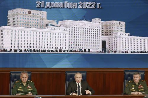 Russian President Vladimir Putin, center, speaks as Russian Defense Minister Sergei Shoigu, left, and Chief of the General Staff Gen. Valery Gerasimov attend a meeting with senior military officers in Moscow, Russia, Wednesday, Dec. 21, 2022. 