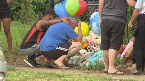 Mr Shorey is comforted at the crash scene where his two sons were killed.