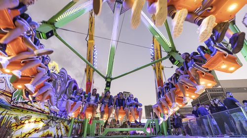 People ride The Beast, which reaches speeds of 120km/h and swings 38 metres high while doing a 360 degree spin, at the The Sydney Royal Easter Show on 05 April, 2021. Photo: Brook Mitchell