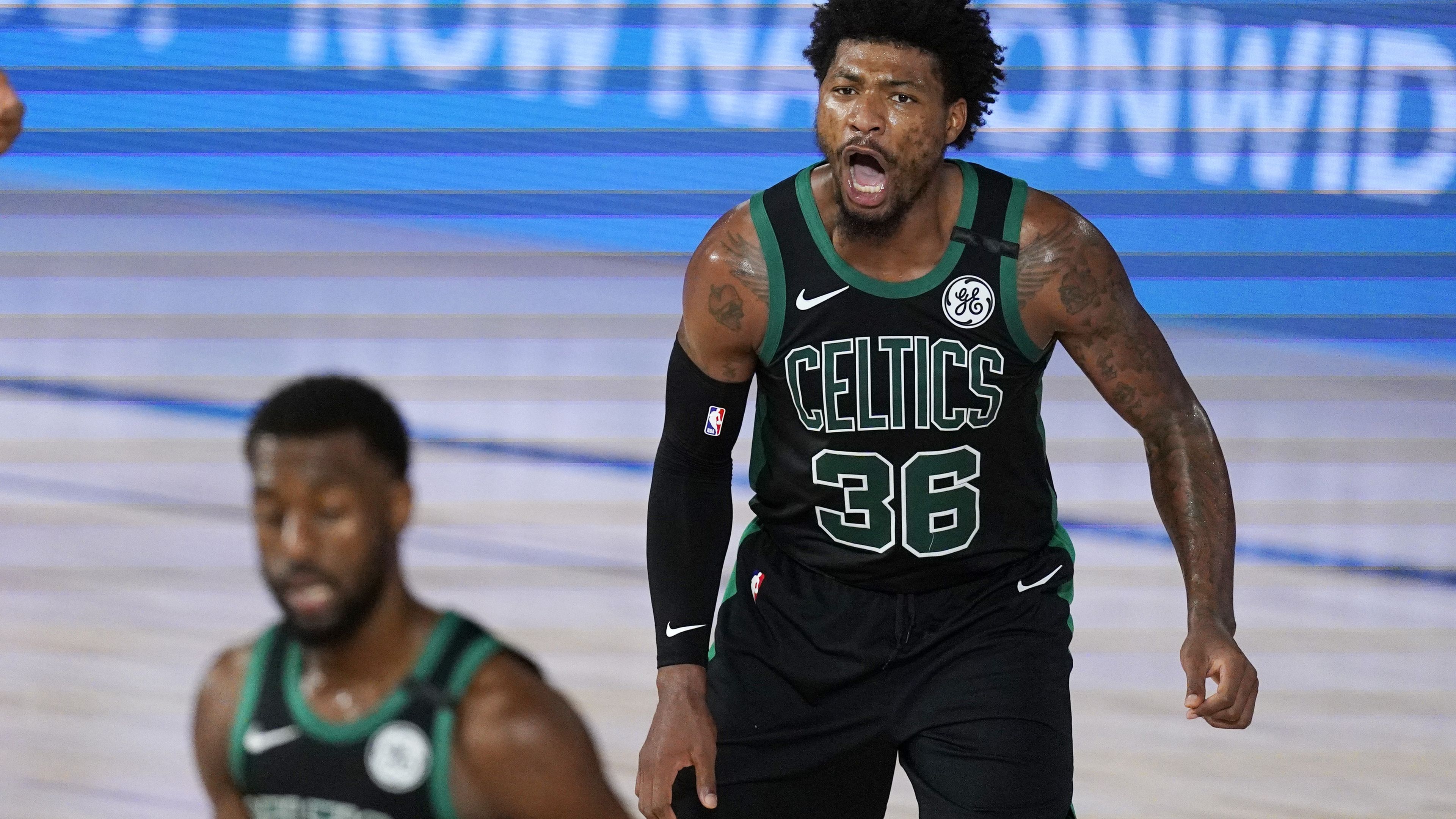 Boston Celtics guard Marcus Smart yells at his team after scoring.