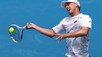 MELBOURNE, AUSTRALIA - JANUARY 10: John Millman of Australia plays a forehand during a training session ahead of the 2024 Australian Open at Melbourne Park on January 10, 2024 in Melbourne, Australia. (Photo by Kelly Defina/Getty Images)