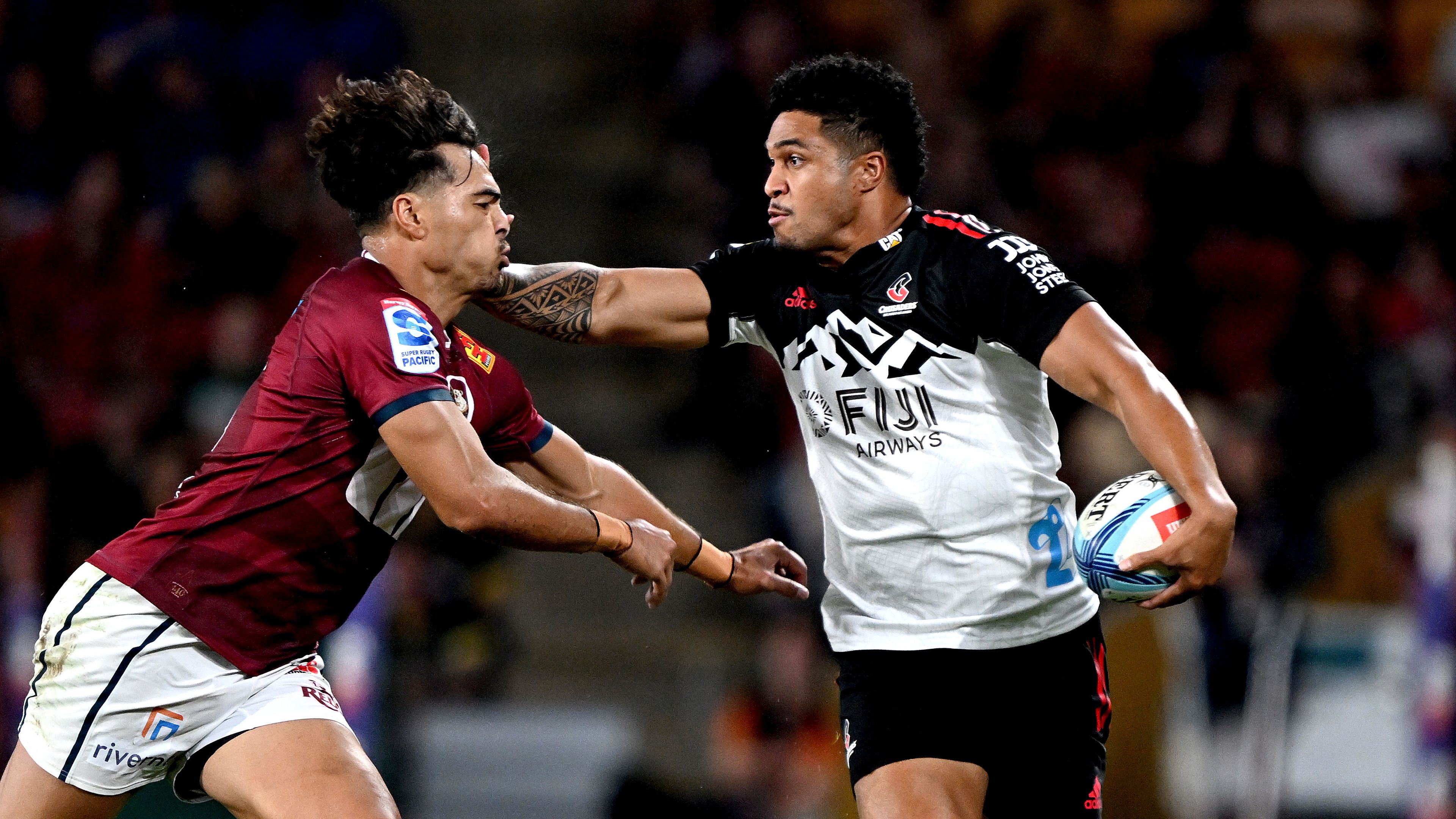 Leicester Fainga&#x27;anuku of the Crusaders takes on the defence of Jordan Petaia of the Reds.