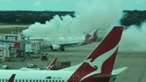 A fire erupted within metres of a Qantas plane at Melbourne Airport on Saturday afternoon.