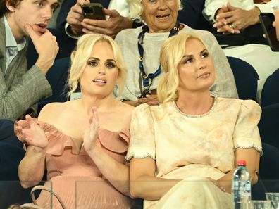 MELBOURNE, AUSTRALIA - JANUARY 12: Rebel Wilson and wife Ramona Agruma watch the Men's Singles First Round match between Alexander Zverev of Germany and Lucas Pouille of France during day one of the 2025 Australian Open at Melbourne Park on January 12, 2025 in Melbourne, Australia. (Photo by Hannah Peters/Getty Images)
