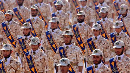 Iranian revolutionary guard soldiers march during the 2013 annual military parade marking the Iraqi invasion in 1980, which led to an eight-year-long war.