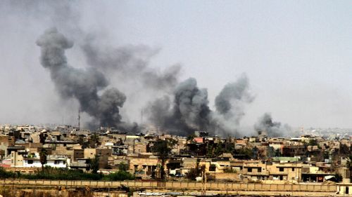 A general view showing smoke clouds rising from the western part of Mosul city, Iraq during a gruelling battle between Iraqi security forces and ISIS.