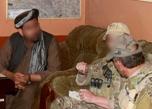 Former ADF soldier Shane Healey (middle) meets with a local Afghan on a 2012 mission in Uruzgan province.