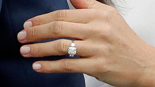 Britain's Prince Harry's fiancee Meghan Markle shows off her engagement ring. (AAP)