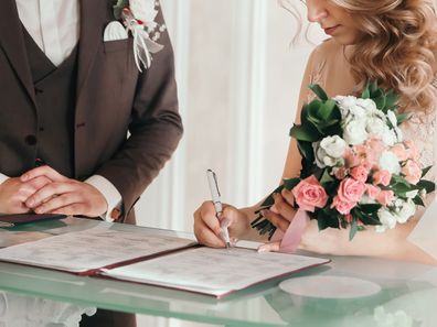 Bride and groom signing the marriage contract. 