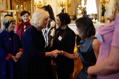 Queen Camilla greets Victoria Beckham