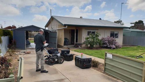 Police outside Colleen Adams' home in Maitland.