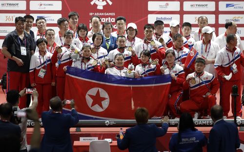 The victorious North Korean weighlifting team at the Asian Games in Jakarta show off their medals yesterday.