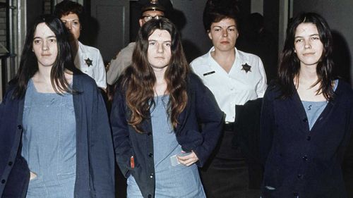 Susan Atkins, Patricia Krenwinkel and Leslie Van Houten are marched to court in 1971, sporting X-shaped scars on their foreheads. (AAP)