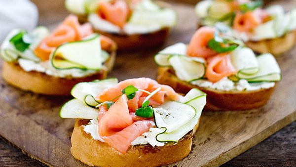 Barbecued garlic bread topped with goat's curd, smoked salmon and zucchini ribbons