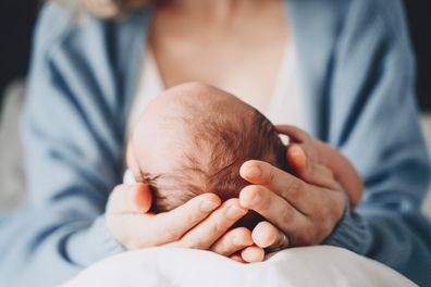 Newborn in mother's hands. 