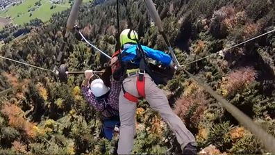 The man, who was on holiday in Swizerland, was forced to hang onto the craft with his bare hands as it soared over valleys.