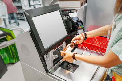 Cashier scans item at checkout in the grocery supermarket shop