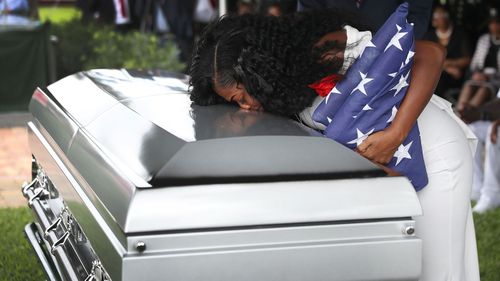 Myeshia Johnson kisses the casket of her husband.