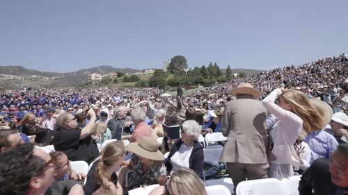 A pelican flew into the crowd, landing among the seated audience. (YouTube: Grant Dillion)