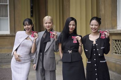 L-R: Lisa (Lalisa Manoban), Rose (Roseanne Park), Jisoo Kim and Jennie Kim, from the K-Pop band Blackpink pose with their Honorary MBEs