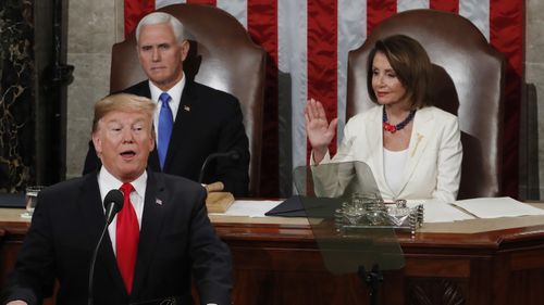 US President Donald Trump gives the SOU speech as Vice President Mike Pence and House Speaker Nancy Pelosi look on.