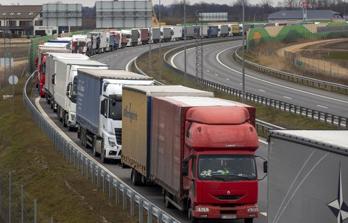 Traffic jams swelled along borders and travellers appealed to their governments for help getting home Tuesday as countries in Europe and beyond imposed strict controls along their frontiers.