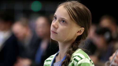 Swedish climate activist Greta Thunberg listens to speeches before addressing a plenary of U.N. climate conference at the COP25 summit in Madrid, Spain