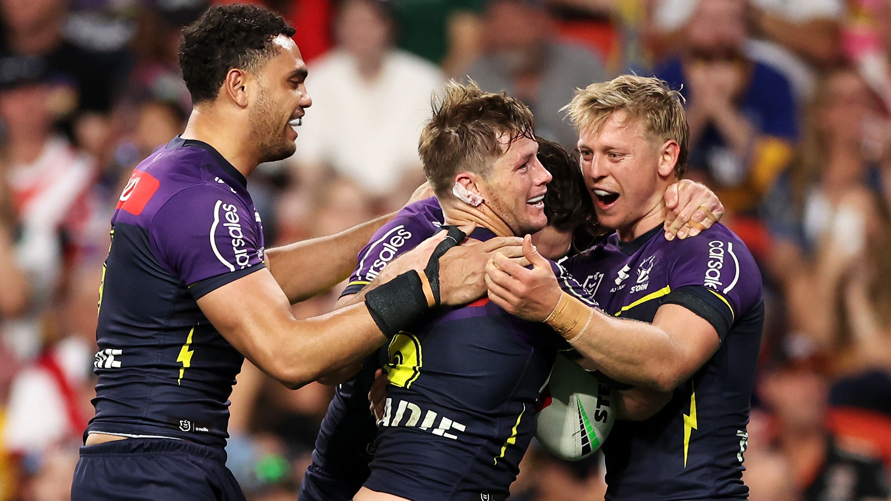 Harry Grant of the Storm celebrates with his teammates after scoring a try against the Eels.