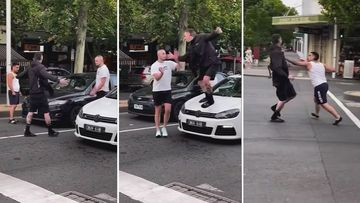 Footage has emerged of two men trading blows in the middle of a busy Melbourne bringing traffic to a standstill.